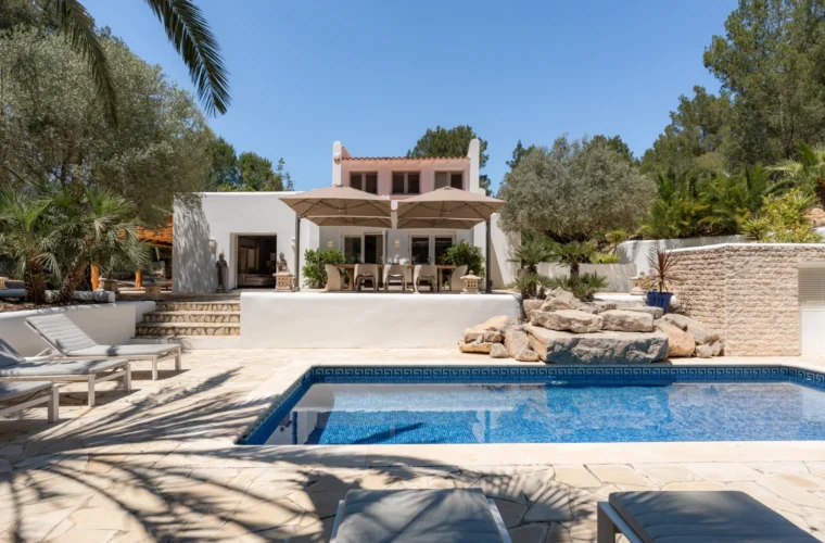 Swimming pool with sun loungers at a villa for sale in Es Cubells, Ibiza