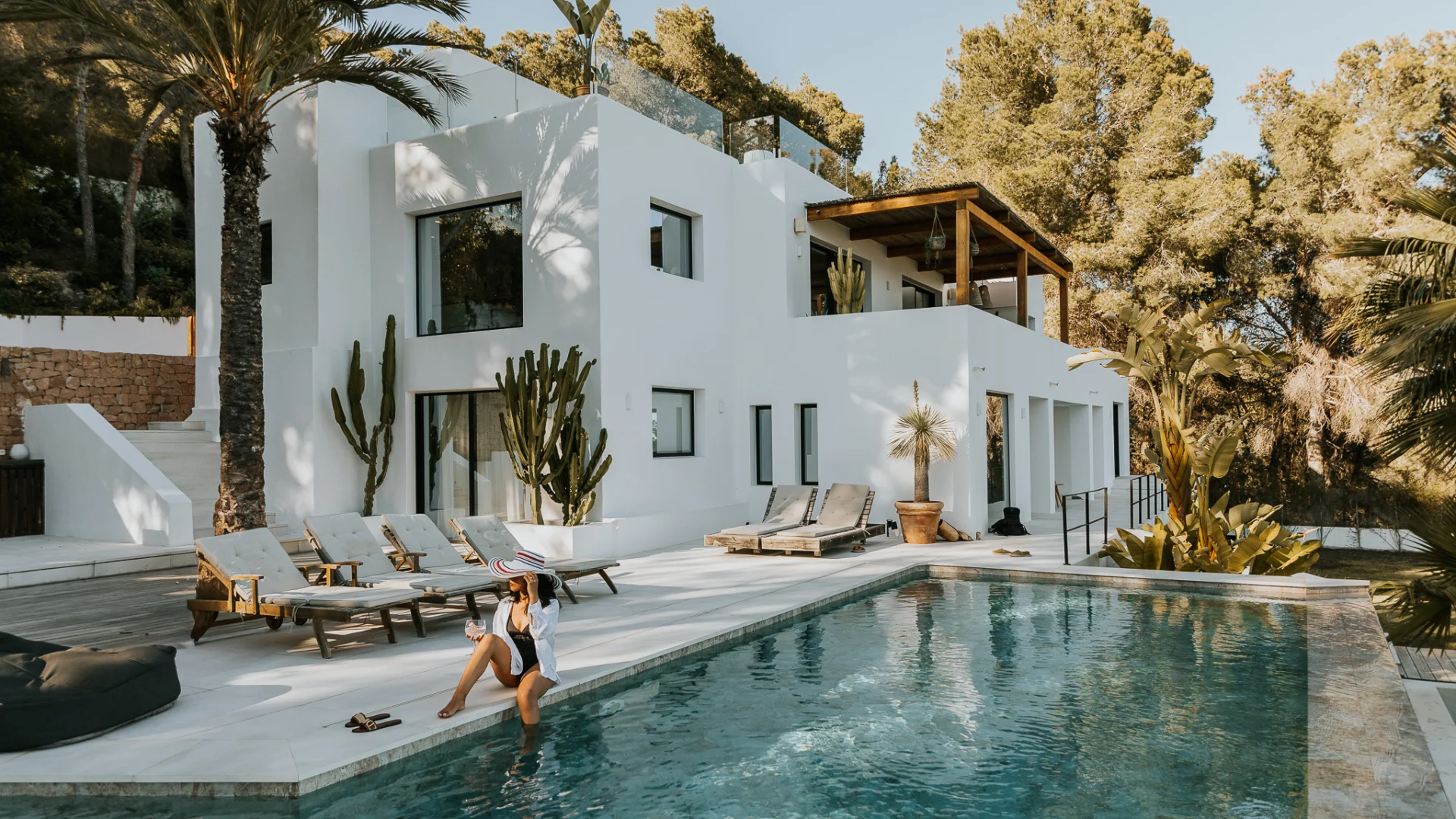 Pool and sun loungers with cactus garden at a villa in Es Cubells, Ibiza